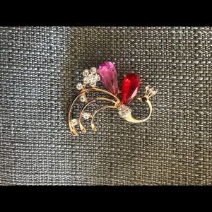 Red and pink peacock brooch